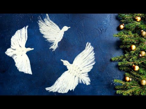 three white doves flying in the air next to a christmas tree