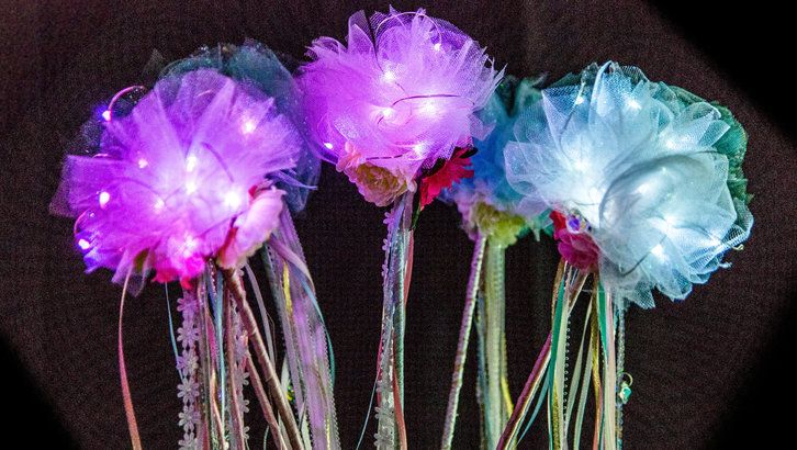 three purple and blue flowers in a vase