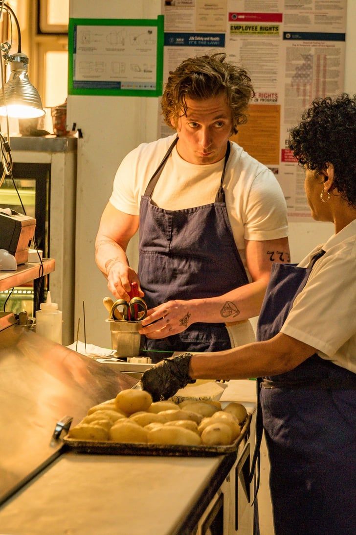 two people working in a bakery making donuts on a counter top with one person pouring something into a bowl