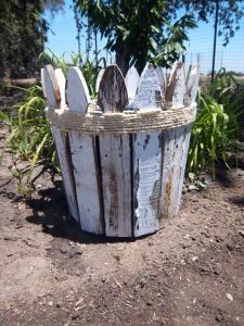 an old wooden fence is sitting in the dirt