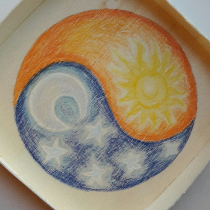 a drawing of a sun and moon on a ceramic dish with blue, yellow and orange colors