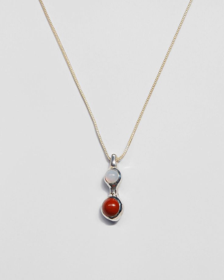 Red jasper and blue chalcedony nestled in a sculptural solid brass or sterling silver setting. Sterling silver chain is adjustable from 18-20 inches, closes with a lobster clasp. Pendant measures 1.25" from top to bottom, just under .5" wide. Availability: Made to order, ships in 2-4 weeks. Need it sooner? Don't hesitate to get in touch and we'll do our best to accommodate. Adjustable Sterling Silver Jewelry With Large Pendant, Red Agate Pendant Jewelry, Silver Carnelian Gemstone Jewelry, Unique Adjustable Snake Chain Necklace, Adjustable Gemstone Necklace With Oval Pendant, Adjustable Oval Pendant Gemstone Necklace, Adjustable Sterling Silver Necklaces With Large Pendant, Carnelian Gemstone Oval Pendant Jewelry, Carnelian Pendant Gemstone Jewelry