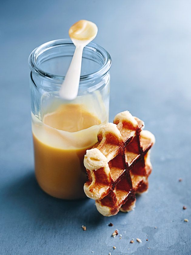 an advertisement for fudge sauces with a spoon sticking out of it's jar