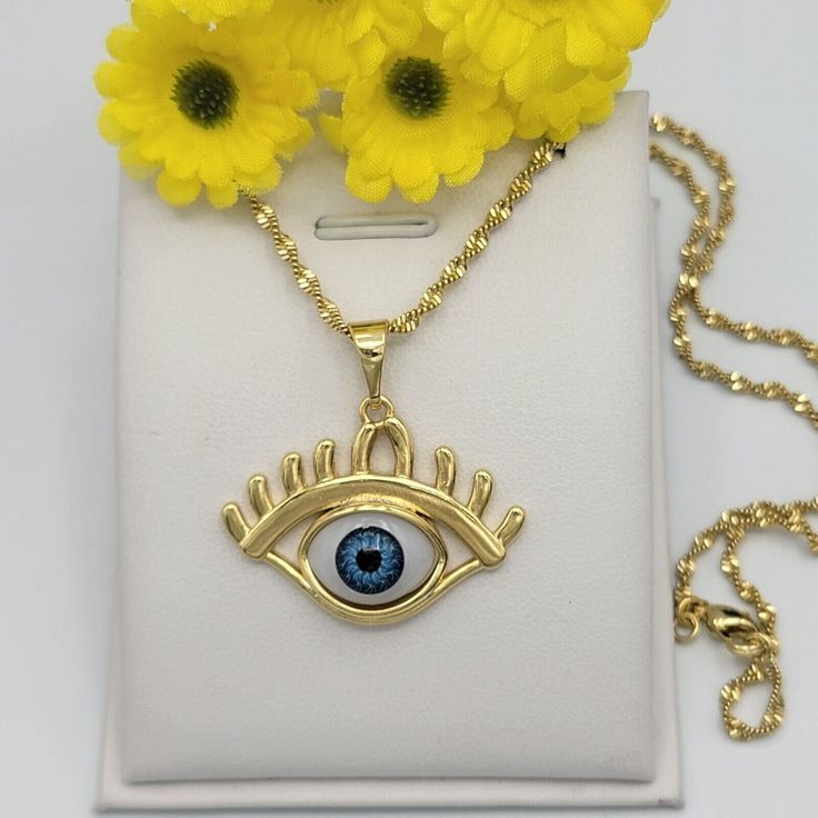 "14K Gold Plated Evil Eye Protection Luck Charm Pendant Necklace. Oro Laminado A B O U T We offer high quality jewelry for all. All items are nicely packaged. Thank you for shopping with us ❤️ Feel free to send a message if you have any questions! * Pendant Shape: Hamsa * Color: Gold * Main Stone Color: Blue * Metal: 14K Gold Plated * Brand: MyDivineSpace * Type: Necklace * Pendant/Locket Type: Amulet * Style: Pendant * Base Metal: Metal Alloy * Theme: Protection * size: 1,25\" h (including bail) * length: 18 inches * Pendant Shape: Hamsa * Color: Gold * Main Stone Color: Blue * Metal: 14K Gold Plated * Brand: MyDivineSpace * Type: Necklace * Pendant/Locket Type: Amulet * Style: Pendant * Base Metal: Metal Alloy * Theme: Protection * size: 1,25\" h (including bail) * length: 18 inches" Gold Evil Eye Necklace As Gift, Elegant Gold Evil Eye Necklaces, Elegant Gold Evil Eye Necklace, Cadmium-free Yellow Gold Necklace For Gifts, Protection Pendant, Evil Eye Protection, Luck Charm, Charm Pendant Necklace, Luck Charms