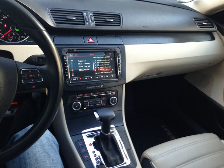 the interior of a car with dashboard controls and steering wheel, including an electronic display