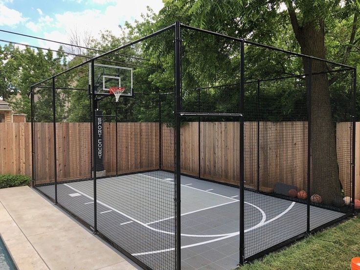 an outdoor basketball court in the back yard