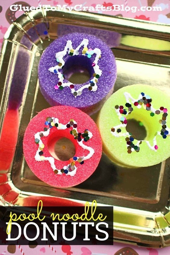 three doughnuts with sprinkles on them sitting in a metal tray