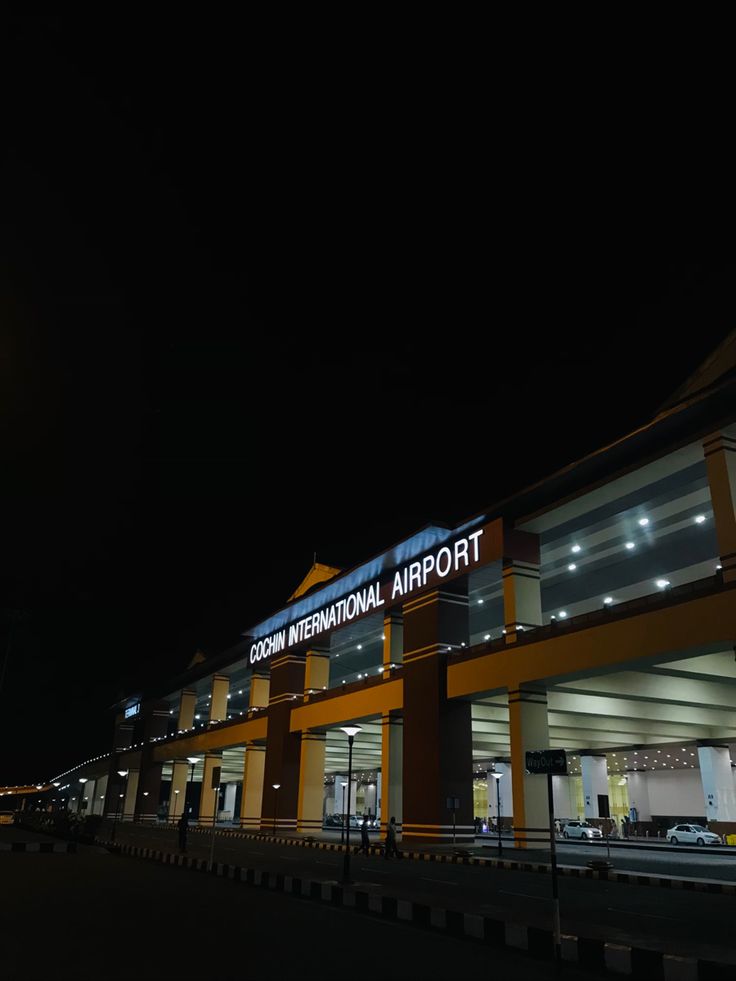 an airport building lit up at night time