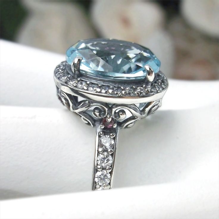 Aquamarine Sterling Silver RingHalo Design #D228 If you have a penchant for classic vintage jewelry, then this beautiful simulated aquamarine Halo Ring #D228 is just the thing for you. Crafted with love in sterling silver filigree and a magnificent centerpiece – an 11x9mm Sky Blue gemstone – this ring is sure to become your favorite piece of jewelry. With all the amazing & intricate details plus the lovely oval center stone, this Art Deco design will surely turn heads and get attention wherever Vintage Sapphire Topaz Ring For Formal Occasions, Vintage Blue Topaz Ring Hallmarked, Vintage Blue Topaz Hallmarked Ring, Vintage Aquamarine Gemstone Jewelry, Elegant Handmade Topaz Ring For Anniversary, Handmade Elegant Topaz Ring For Anniversary, Antique Blue Jewelry For Wedding, Antique Blue Wedding Jewelry, Formal Light Blue Round Jewelry