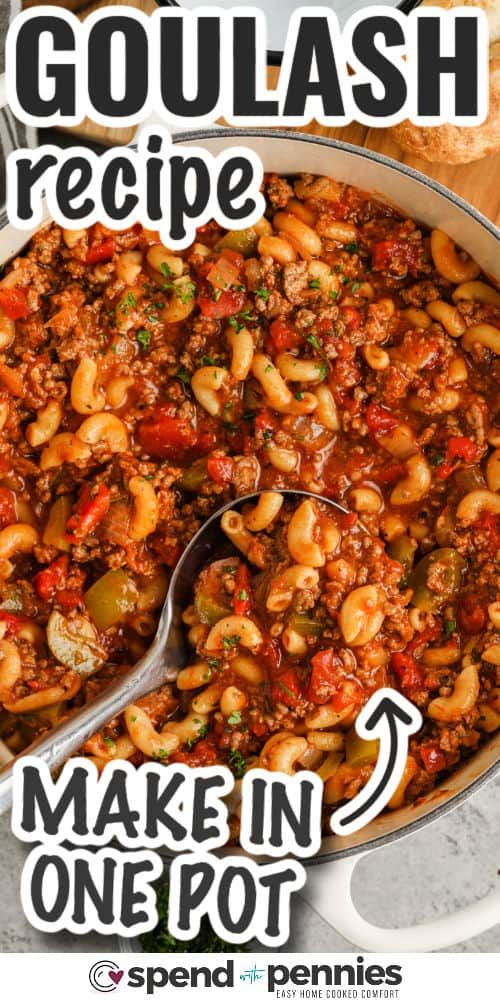 a pot filled with pasta and beans on top of a wooden table