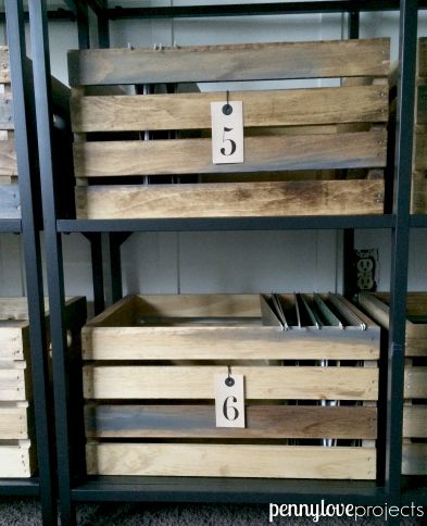 several wooden crates with numbers on them in a storage area at a store or office