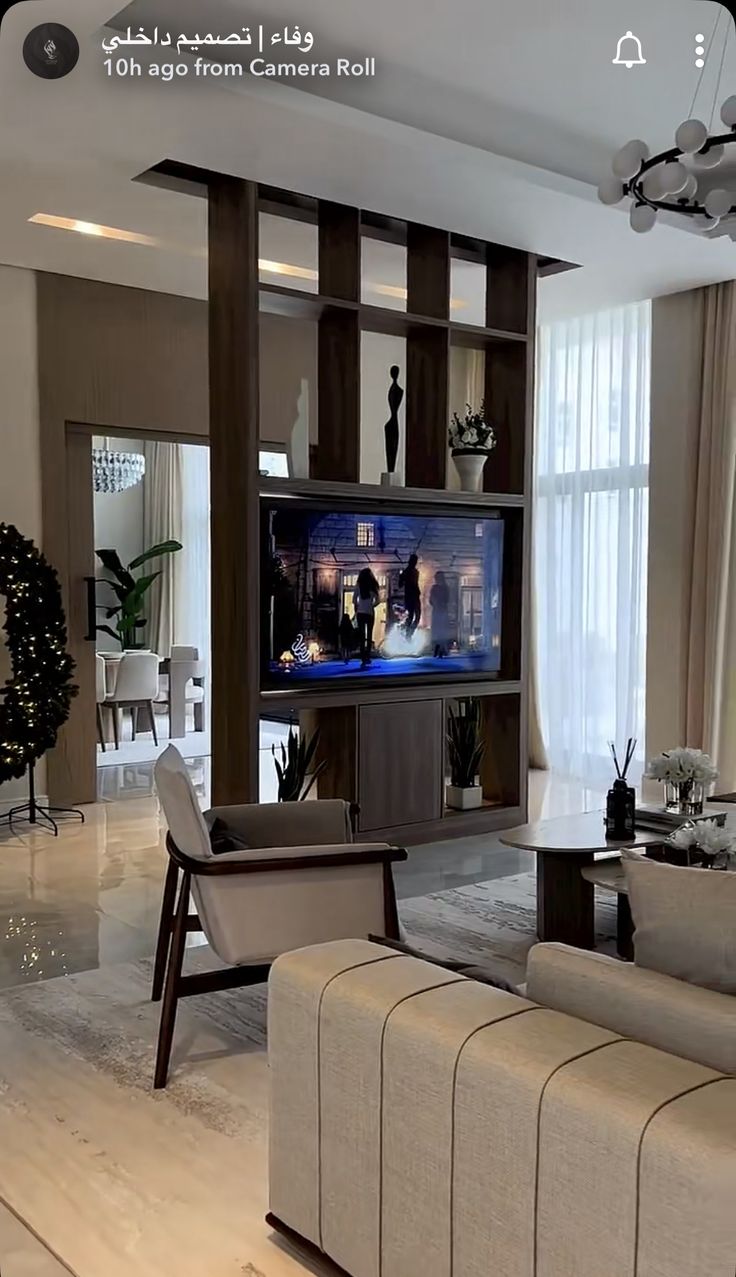 a living room filled with furniture and a flat screen tv mounted to the wall above it