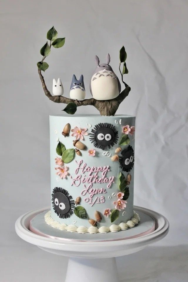 a birthday cake decorated with animals and flowers