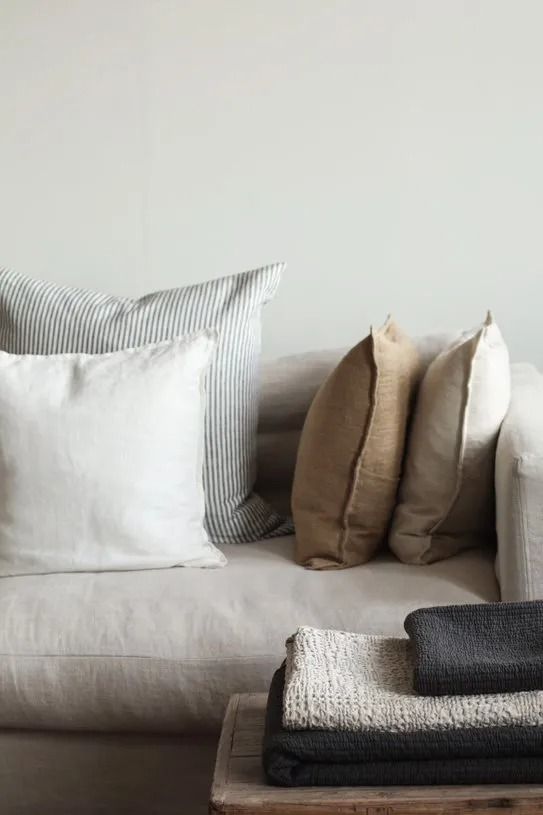 a white couch with several pillows on it