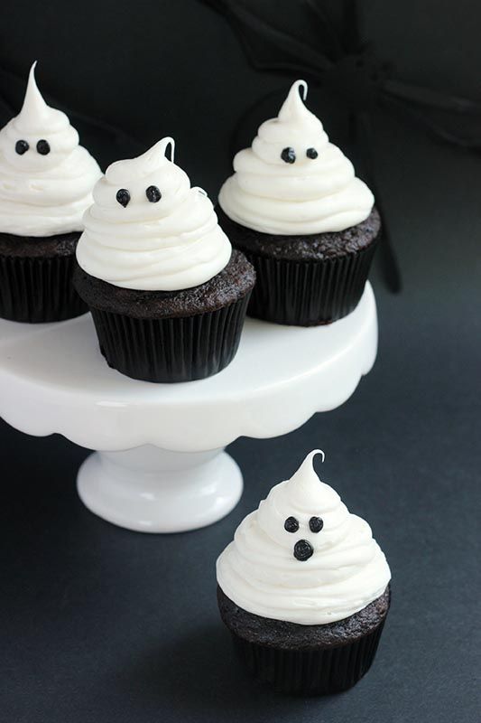 cupcakes with white frosting and spooky eyes