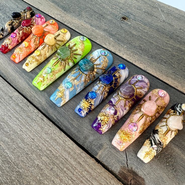 This stunning set features genuine stones like amethyst, rose quartz, aventurine, and lapiz lazuli. Each nail is it's own colour of the rainbow with a matching gemstone placed securely within a hand-drawn sun painted with gold chrome. I hand-paint the marbled effect on every nail, making each set unique and special. I truly hope you'll enjoy wearing these nails as much as I enjoy creating them! *The shape shown in the pictures is the XL COFFIN. *Colours may appear a little different due to your Nail Making, Art Chakra, Acrylic Press On Nails, Moon And Sun, Celestial Art, Art Gold, Gold Chrome, Crystal Nails, Gold Moon