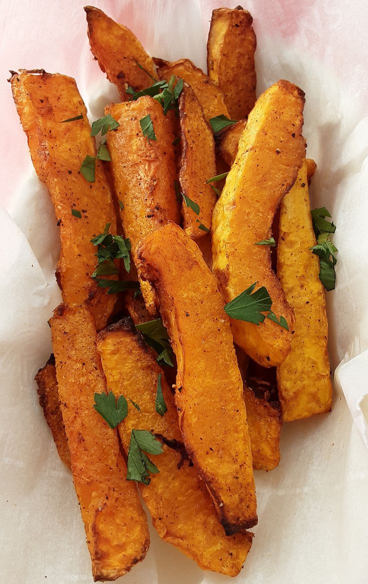 a pile of fried potatoes with parsley on top