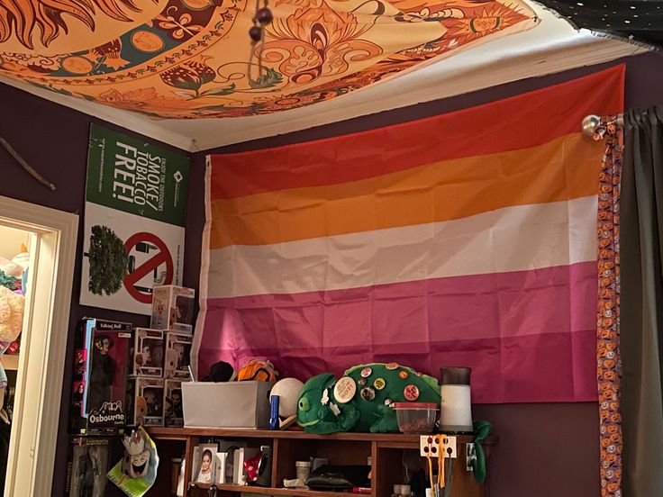 a room with a large colorful flag hanging from the ceiling