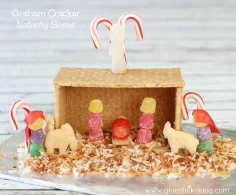 a gingerbread house with candy canes and candies in the shape of people