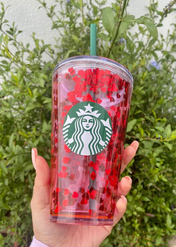 a starbucks cup with red sprinkles on it