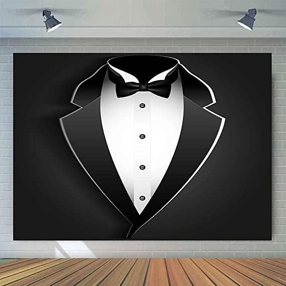 a black and white tuxedo wall hanging on a brick wall in an empty room