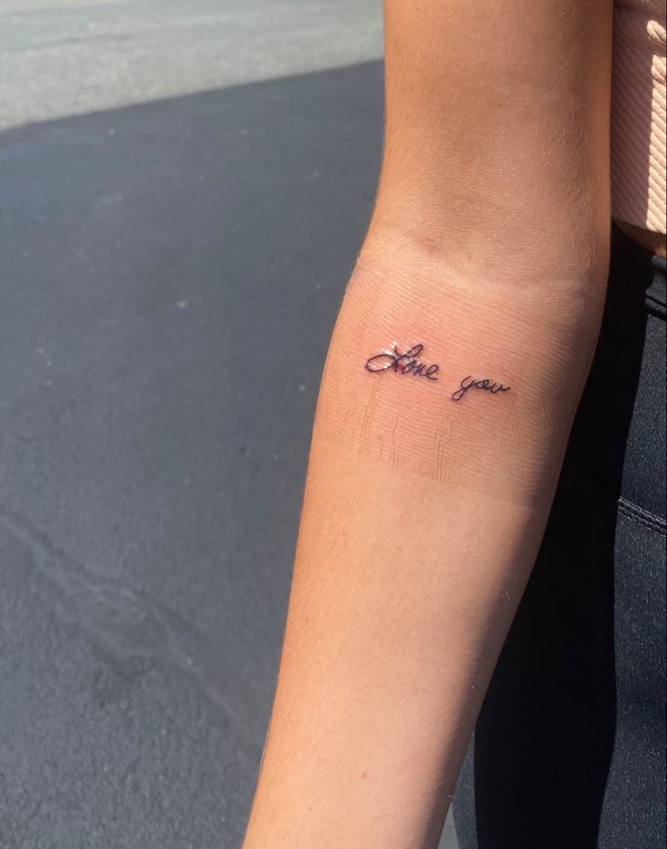 a woman's arm with a tattoo that reads, coffee and love on it