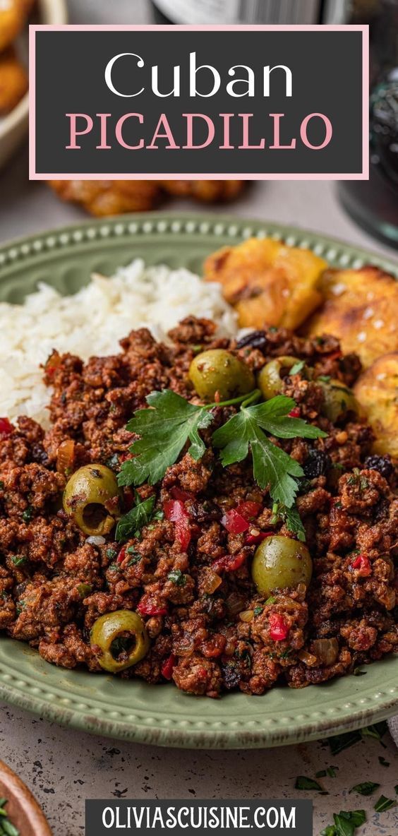 a green plate topped with meat and olives next to rice on top of a table