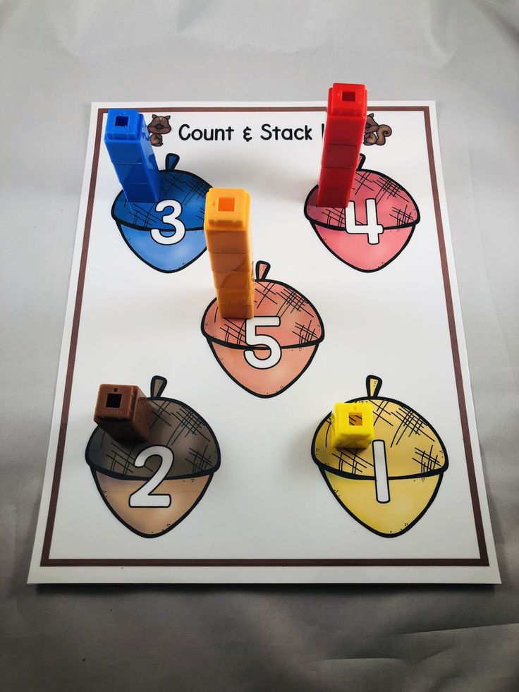 an apple themed counting game is displayed on a sheet of paper with numbers and shapes