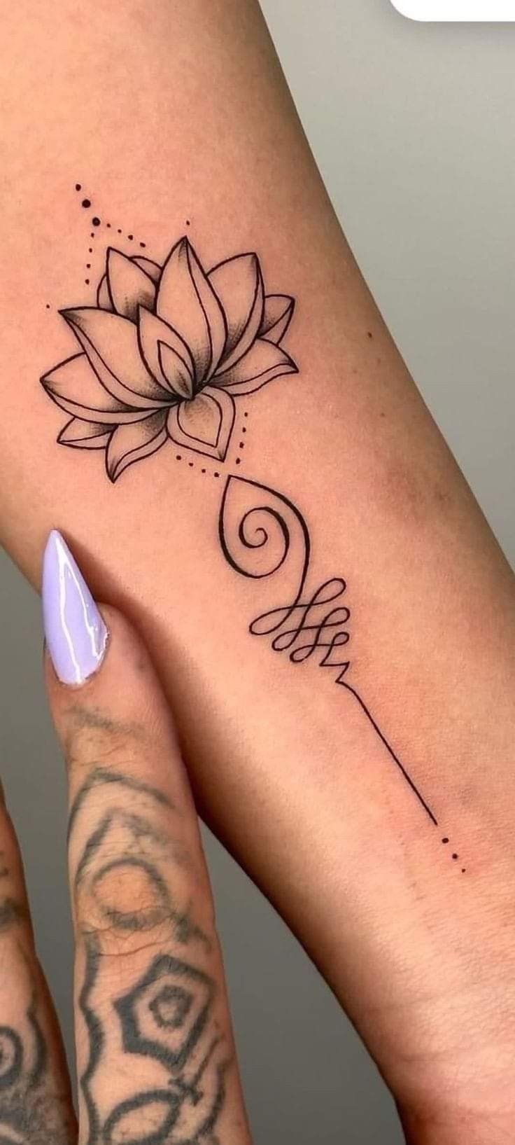 a woman's foot with a lotus tattoo on it