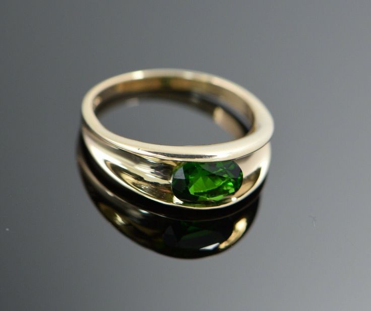 This is a 14K Yellow Gold ring with channel set green stone, oval shape, Modern, stone approximately 8 x 10 mm, Ring Size 8, Weight 4.1 grams. Stock # BB93R26 This listing contains photographs of the actual item you will receive. Our items are in excellent condition with little or no signs of wear and many are one of a kind pre-owned estate finds. Please look closely at the pictures in this listing as they are part of the product description. Please read the description, as any imperfections or Green Stone Ring, Green Stone Rings, Bezel Set Ring, Set Ring, Channel Set, Boston Ma, Yellow Gold Ring, Green Stone, Stone Ring