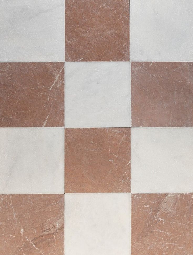 a white and brown checkered tile floor with no pattern on the tiles, it looks like marble