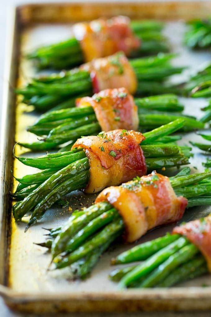 asparagus wrapped in bacon on a baking sheet ready to be served for an appetizer