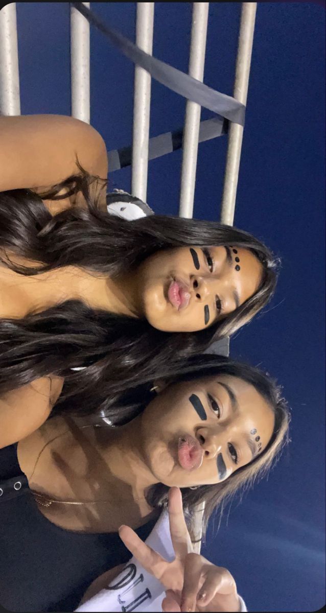 three women are posing for the camera with their faces painted