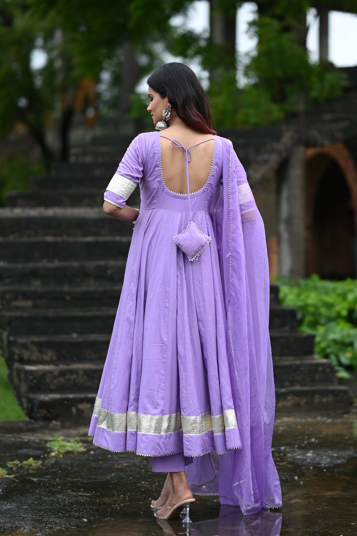 PRODUCT DESCRIPTION :-Shine bright like sunshine!Anarkali :- Pure cottonPant :- CottonDupatta :- Organza silkClosure Used:- Side zipColor:- Lilac purpleCare Instructions :- Dry clean onlyModel Size :- Model is wearing XS sizeModel Height :- 5.5DISCLAIMER :- Slight color variations may occur due to different screen resolution. Purple Silk Kurta With Gota Work, Purple Anarkali Style Sharara With Cutdana, Bollywood Style Cotton Silk Traditional Wear In Purple, Purple Salwar Kameez With Gota Work For Wedding, Bollywood Style Purple Cotton Silk Traditional Wear, Purple Churidar For Wedding With Pallu Detail, Traditional Drape Purple Salwar Kameez With Gota Work, Traditional Purple Gota Work Salwar Kameez, Purple Anarkali Sharara In Art Silk