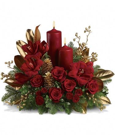 a christmas card with candles, flowers and pine cones on the front cover in red