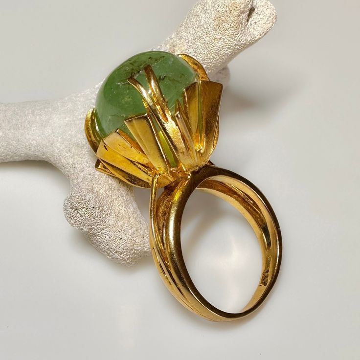 Art Nouveau/Art Deco c1930s-40s This is a very ornate early 14k solid gold ring, featuring a massive 14 ct. Emerald Cabochon. The goldwork appears to be egyptian revival in the shape of Lotus, making this an outrageous statement ring. Simply stunning. 11.6g  14k solid yellow gold Hallmarked Columbian Emerald Cabochon 14 Carats Crown height 16.7 mm S 6.5 US resizable Fine antique condition Antique Emerald Ring In Yellow Gold, Vintage Formal Dome Ring, Vintage Dome Ring With Polished Finish For Wedding, Art Deco Gold Emerald Ring, Vintage Polished Dome Ring For Wedding, Antique Yellow Gold Emerald Ring, Vintage Yellow Gold Emerald Ring, Vintage Gemstone Dome Ring For Anniversary, Vintage Yellow Gold Round Dome Ring