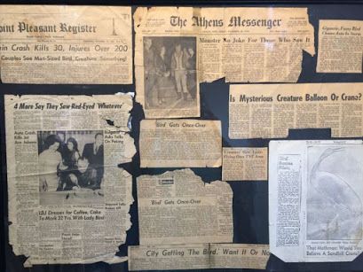 an old newspaper is displayed on the wall with many pieces of paper taped to it