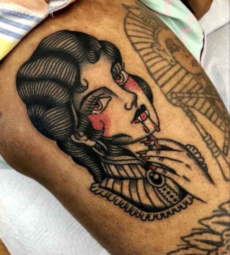 a woman's arm with tattoos on it