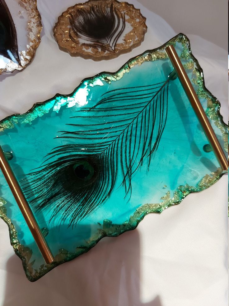 a glass plate with a peacock feather on it