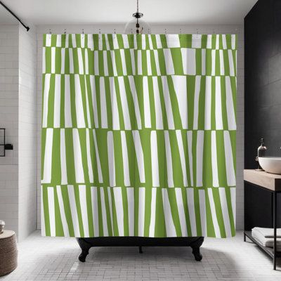 a green and white shower curtain in a bathroom