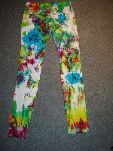 a pair of colorful tie - dyed pants laying on the floor