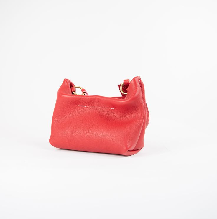 Soft leather baguette bag that transforms into a clutch via a removable strap. Chic Pebbled Leather Shoulder Bag With Removable Pouch, On-the-go Soft Leather Top Handle Baguette Bag, Pebbled Leather Crossbody Shoulder Bag With Detachable Strap, Evening Pebbled Leather Satchel Shoulder Bag, Leather Clutch With Detachable Handle, Evening Soft Leather Hobo Pouch Bag, Evening Hobo Bag In Soft Leather, Evening Pebbled Leather Shoulder Bag, Leather Hobo Bag With Detachable Handle In Clutch Style