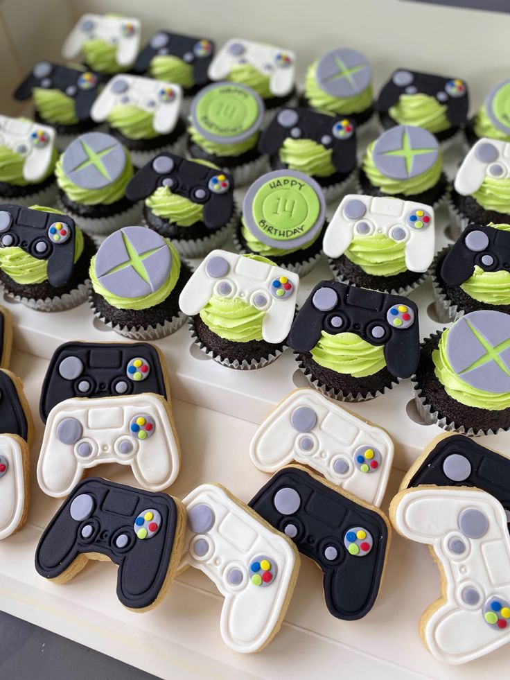 cupcakes decorated with video game controllers are on display