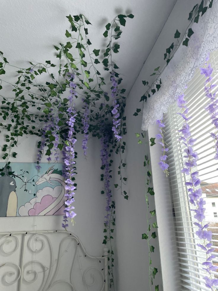 purple flowers hanging from the ceiling in a bedroom