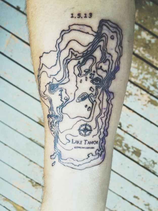 a man's leg with a map tattoo on it, and the words lake tahoe written in blue ink