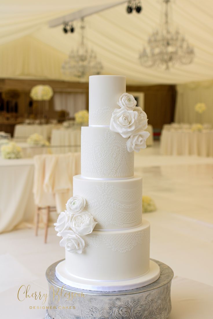 a white wedding cake sitting on top of a table