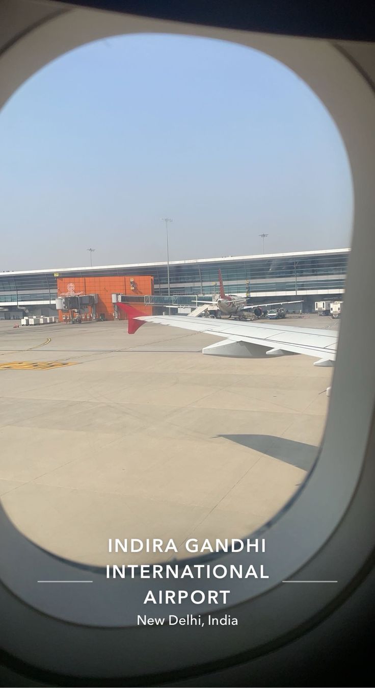 an airplane window with the words india gandhi international airport