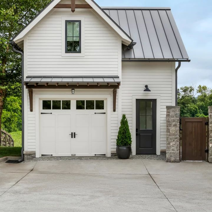 a white house with a black door and windows