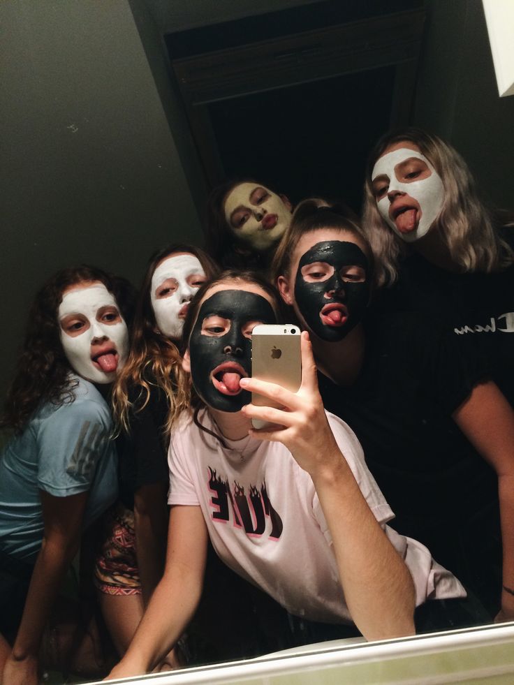 a group of people with painted faces taking a selfie