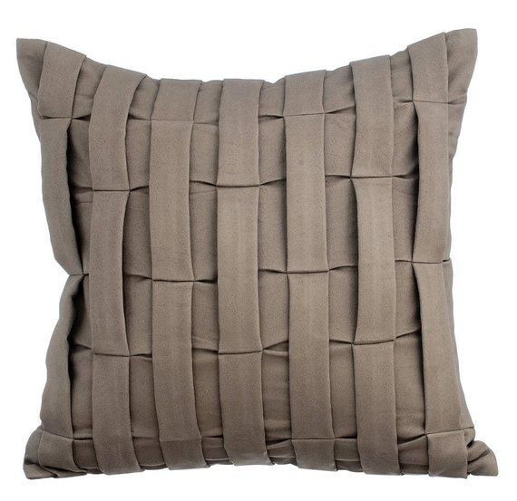 a gray pillow with braiding on the front and back side, against a white background